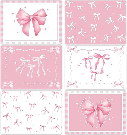 Set of 6 pink plastic placemats with bow and star patterns, rectangular