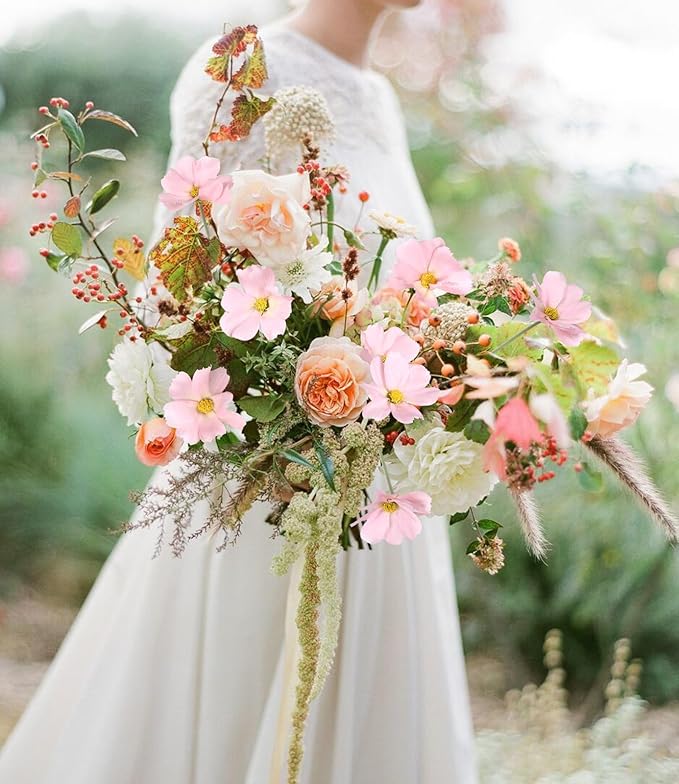 Light pink faux daisy-style stems with green leaves in mixed floral bouquet