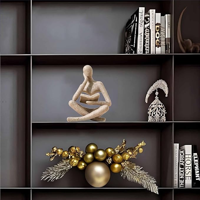 Sandstone-color resin meditation figurine seated cross-legged, holding an open book