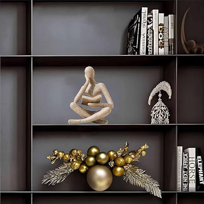 Sandstone-color resin meditation figurine seated cross-legged, holding an open book