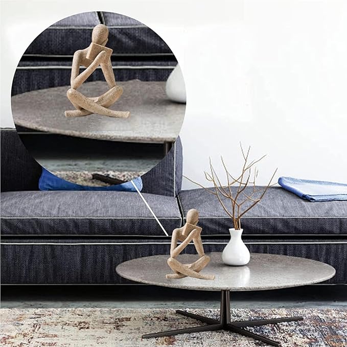 Sandstone abstract resin reading figurine on side table, kneeling reading pose