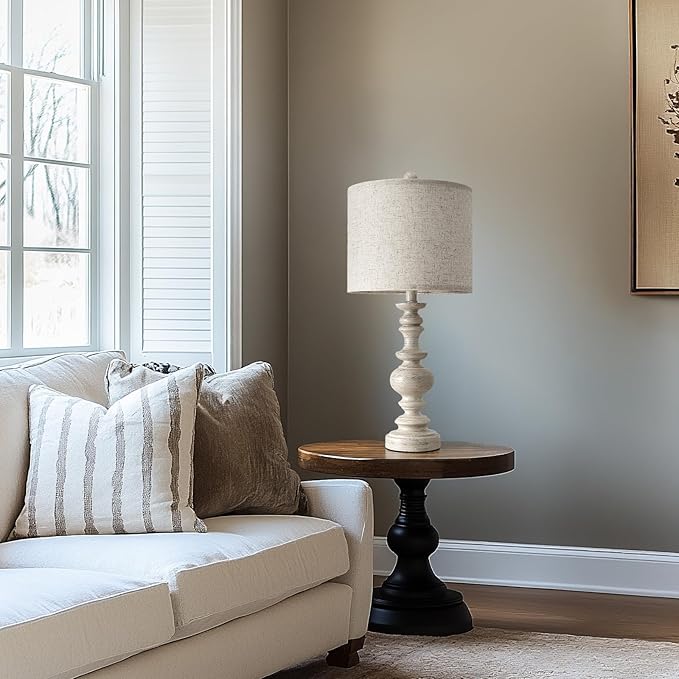 Farmhouse table lamp with beige linen shade and white resin column base with black accent