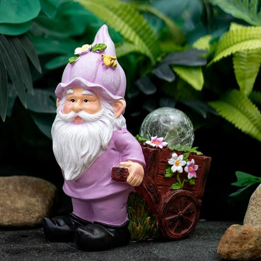 Pink garden gnome figurine with crackle globe light and flower cart, seated pose