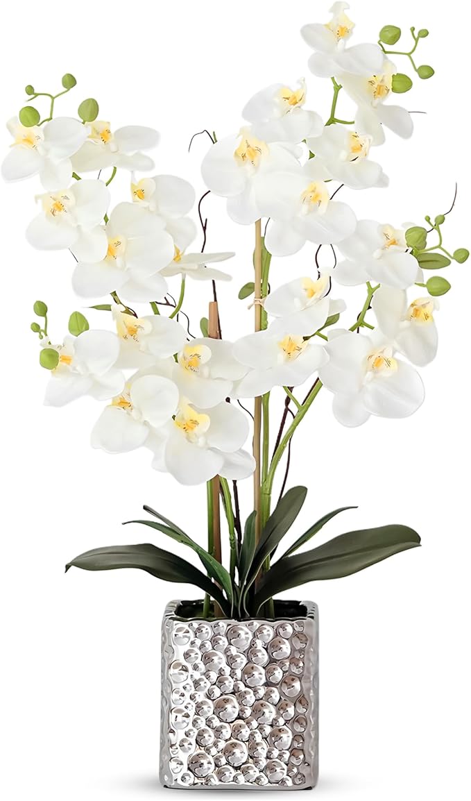 Faux white Phalaenopsis orchid arrangement with green stems in a silver textured vase