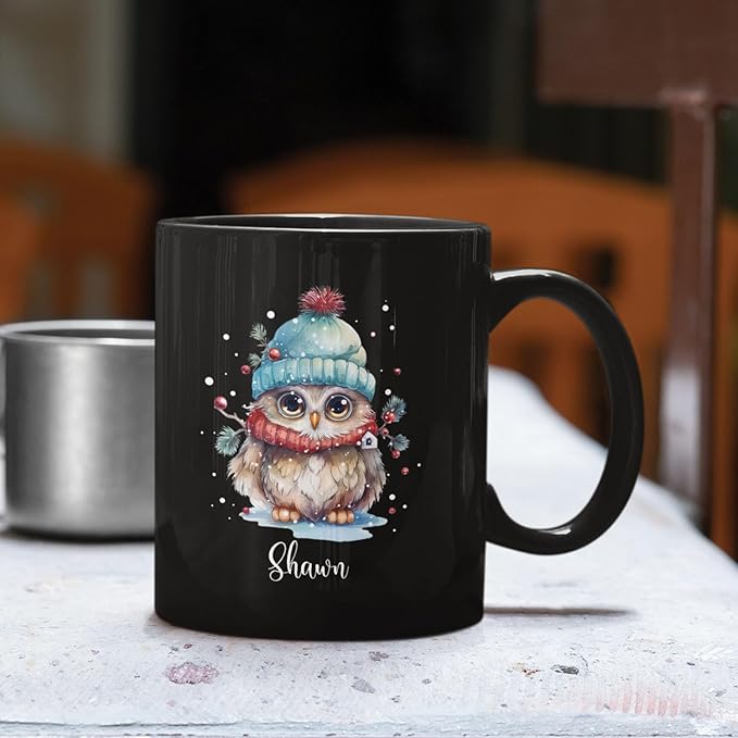 Black ceramic coffee mug with winter owl illustration and 'Shawn' name, front view