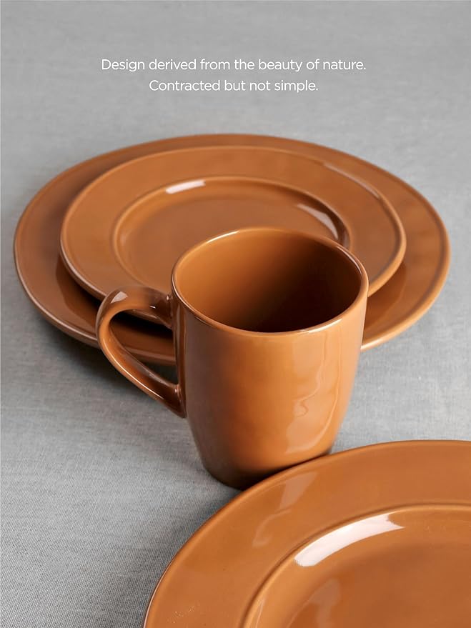 Brown stoneware coffee mug with saucer, glossy reactive glaze, angled view over cup interior