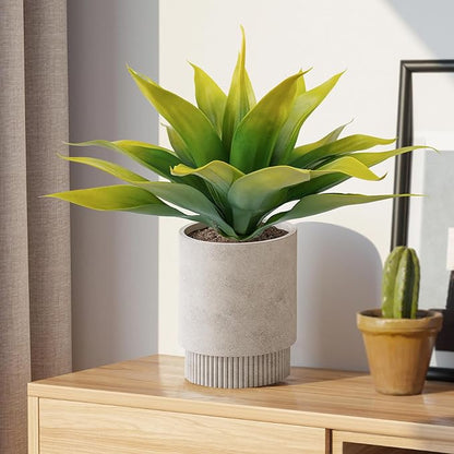 Faux agave plant with yellow-green leaves in a light gray round pot