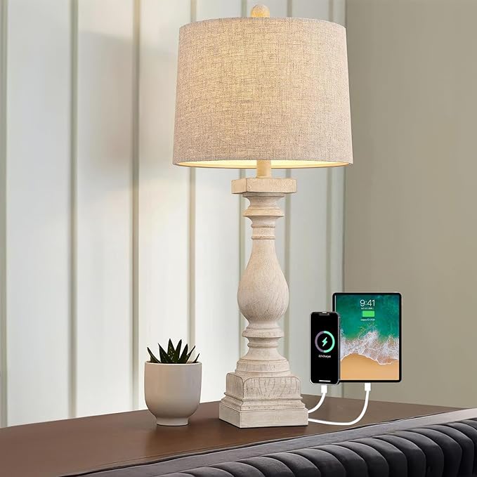Farmhouse table lamp with beige shade and visible USB charging ports on nightstand