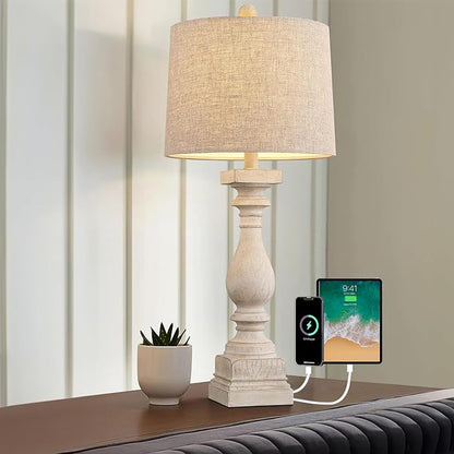 Farmhouse table lamp with beige shade and visible USB charging ports on nightstand