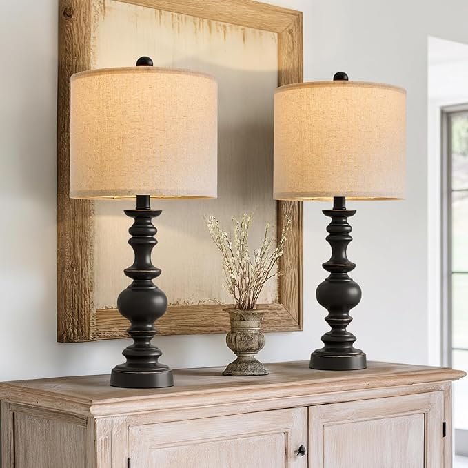 Pair of farmhouse table lamps with turned black resin bases and beige linen drum shades