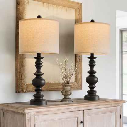 Pair of farmhouse table lamps with turned black resin bases and beige linen drum shades