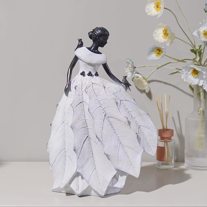 White resin fairy maiden statue standing with layered skirt and raised hand bird figure