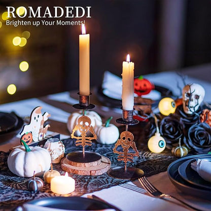 Set of 2 skull gothic taper candle holders with lit candles
