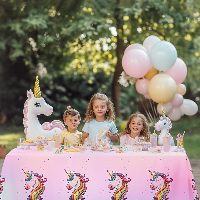 Pink unicorn party tablecloth with rainbow unicorn motifs for disposable table covers