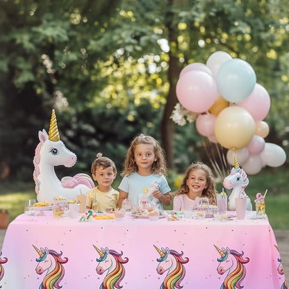 Pink unicorn party tablecloth with rainbow unicorn motifs for disposable table covers