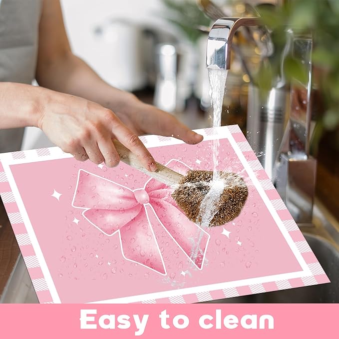 Pink plastic placemat with large ribbon bow design, placed on a tabletop