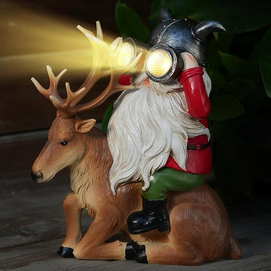 Solar gnome statue on brown deer with antlers, white beard, and glowing lantern