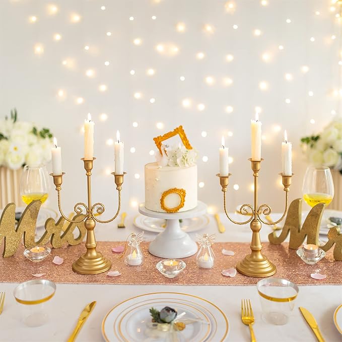 Gold three-stem taper candle holder stand with five arms holding lit white candles