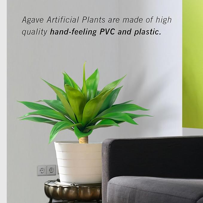 Green faux agave plant with spiky leaves in white textured planter
