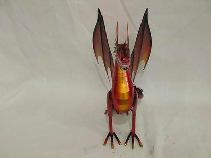 Red dragon figurine on a plain background with wings spread and gold-striped torso