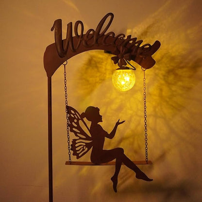Solar fairy garden light with rust stake, fairy cutout, and glowing amber sphere