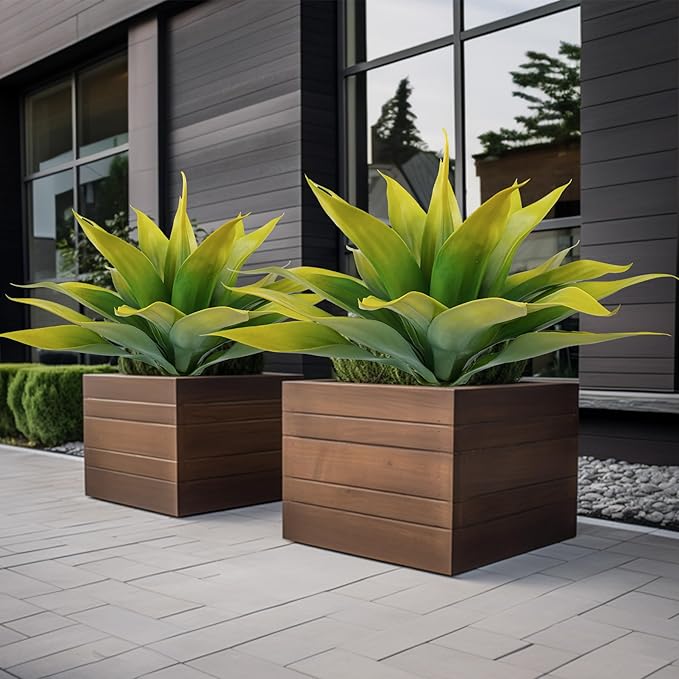 Faux agave plants with yellow-green leaves, two in wooden raised planters
