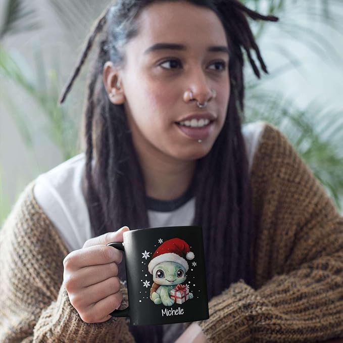 Black ceramic mug with turtle Santa hat design and gift, name Michelle; held in hand