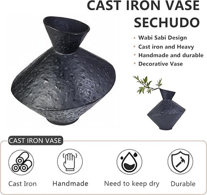 Dark hammered cast iron vase with angled neck, bottle-shaped silhouette