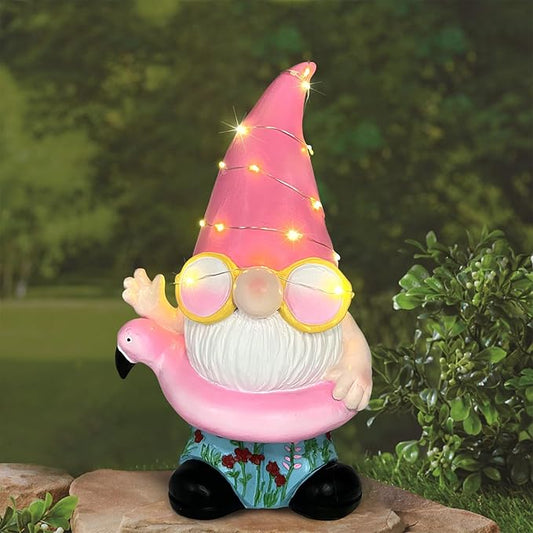 Pink flamingo gnome statue standing with warm LED lights, round glasses, and white beard