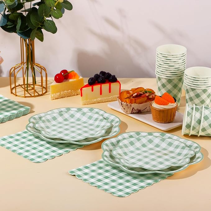 Sage green gingham plates, cups, and napkins arranged for a party table setting