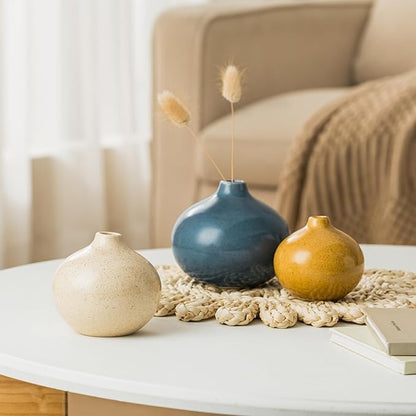 Set of 3 mini ceramic bud vases with pampas stems: blue, gold, and cream.