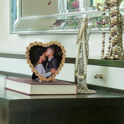 Golden heart-shaped crystal beaded picture frame on a surface, showing couple photo