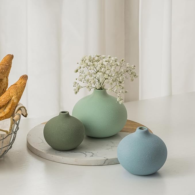 Ceramic bud vase set with three rounded mini vases in sage, mint, and light blue