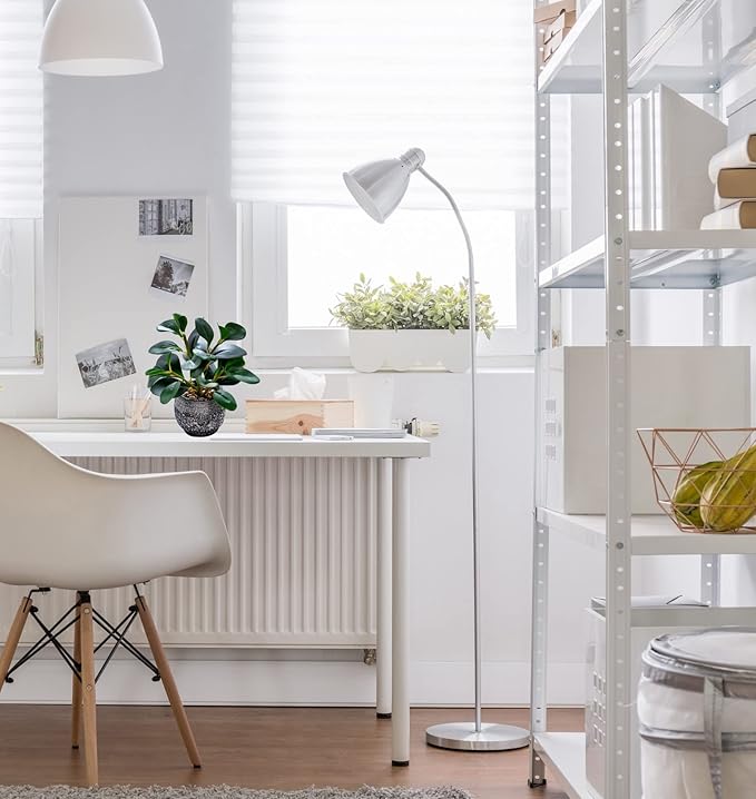 Faux ficus plant in speckled black cement planter beside countertop and sink