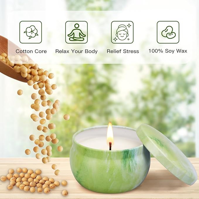 Green soy scented candle in a glass jar with flame; soy beans and leaf on tray