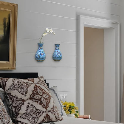 Two blue chinoiserie porcelain wall vases mounted on a white wall