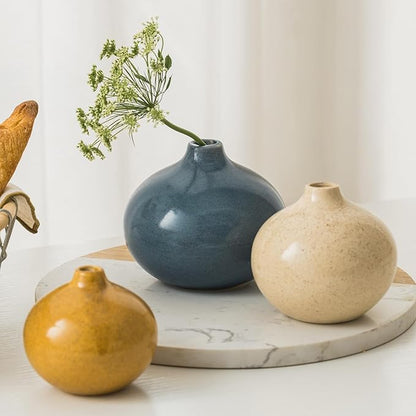 Set of 3 mini ceramic bud vases with stems: blue rounded vase, cream, gold.