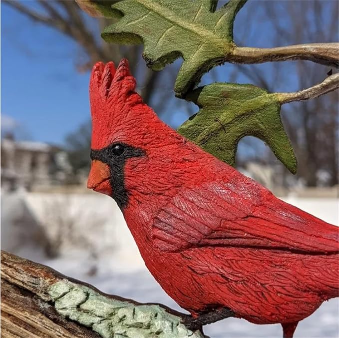 Close-up of red wooden cardinal with black beak on carved branch