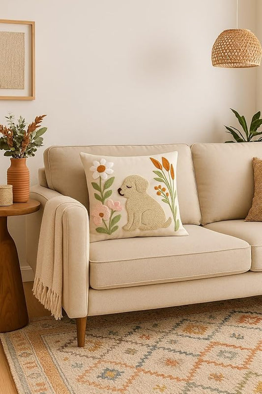 Square embroidered dog pillow cover with floral appliques on a cream sofa