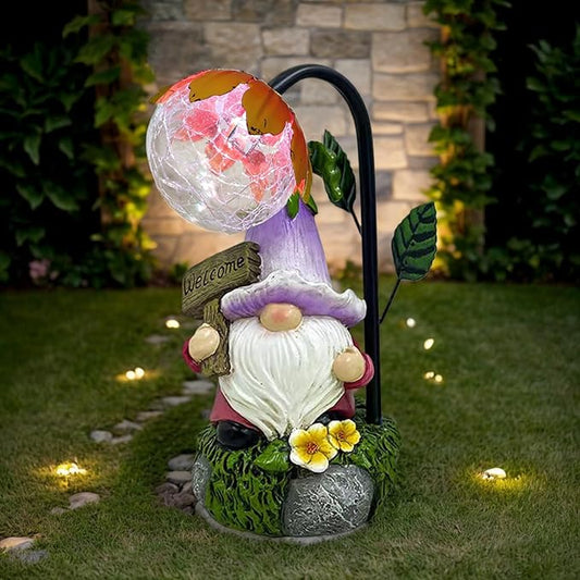 Welcome gnome outdoor solar statue with purple hat, white beard, globe light, green leaf base.