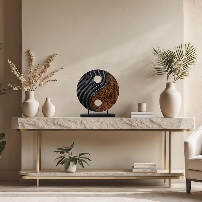 Yin yang wooden sculpture displayed on a mantel shelf, black carved disk with brown center