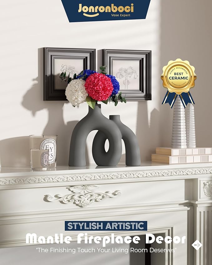 Dark gray matte ceramic conjoined vase sculpture with oval donut cutout on mantel