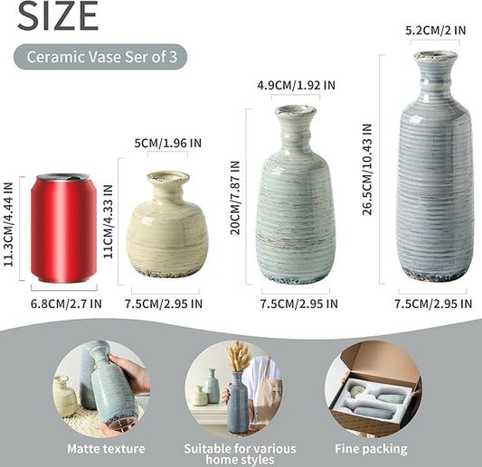 Three ceramic vases set with ribbed finish in cream and blue tones