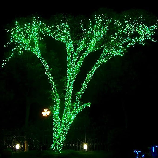 Outdoor tree LED string lights with bright green dots glowing at night
