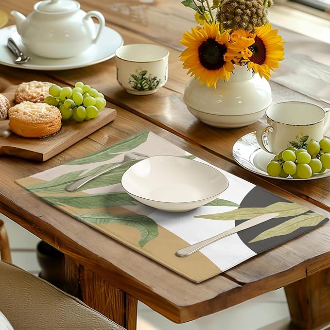 Tropical banana leaf placemat under dinner plate, green leaves on white with tan trim