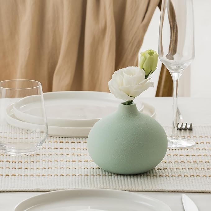 Mini ceramic bud vase in light mint with open neck top on a table setting