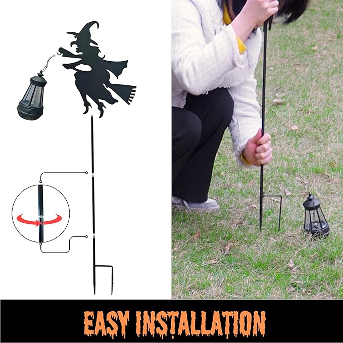 Pair of solar stake witch lantern lights installed in grass with purple LED glow