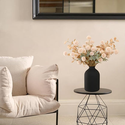 Beige faux pom-pom flower stems with gold eucalyptus sprays in a vase