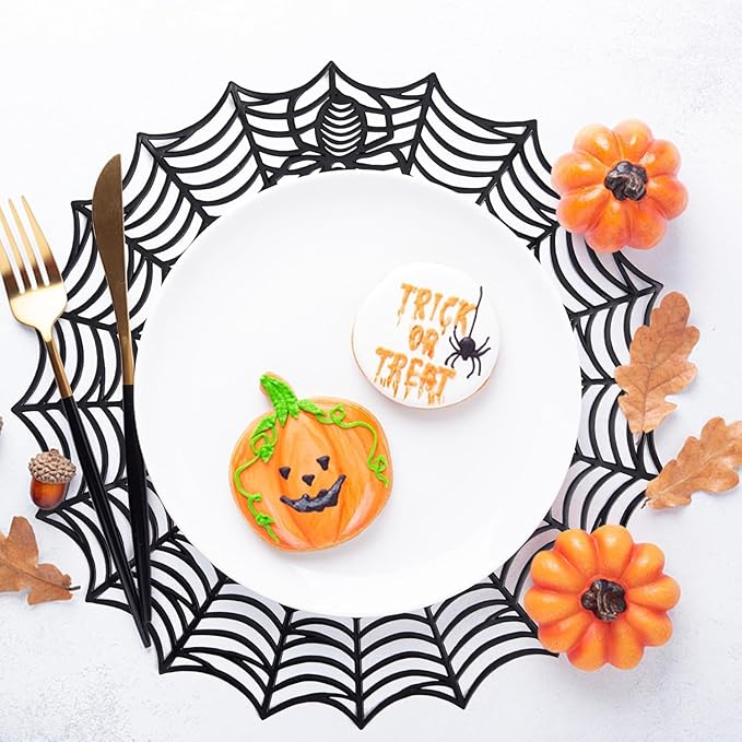Round black spider web PVC placemat framing a white plate and Halloween decorations