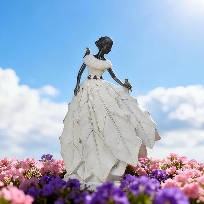 White resin fairy maiden statue outdoors-style on garden flowers backdrop